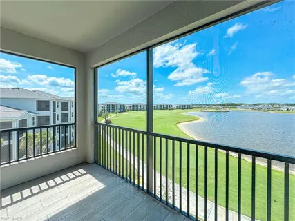 a view of balcony with floor to ceiling windows with wooden floor
