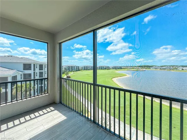 a view of balcony with floor to ceiling windows with wooden floor