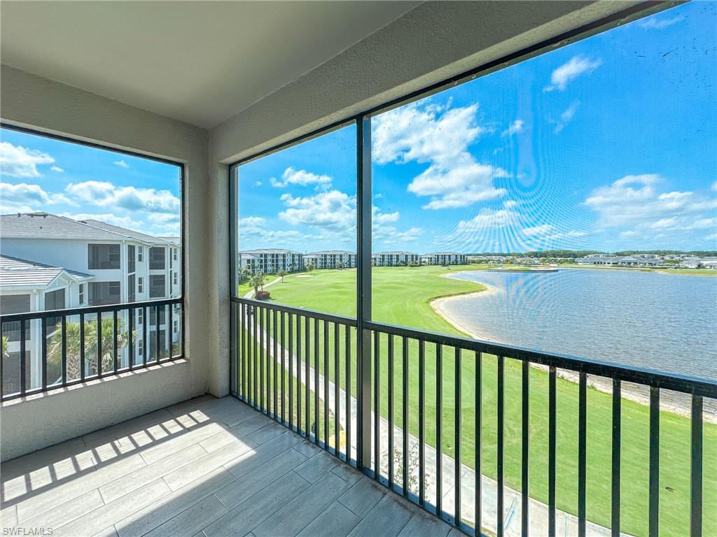 5583 Double Eagle Circle, Unit 4141 Ave Maria, FL 34142 - Photo 15 of 50 a view of balcony with floor to ceiling windows with wooden floor