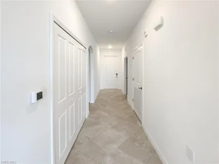 a view of a hallway with white walls