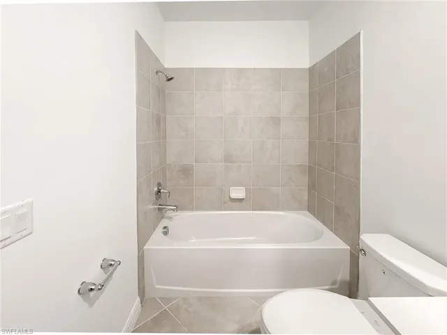a bathroom with a toilet and a bathtub