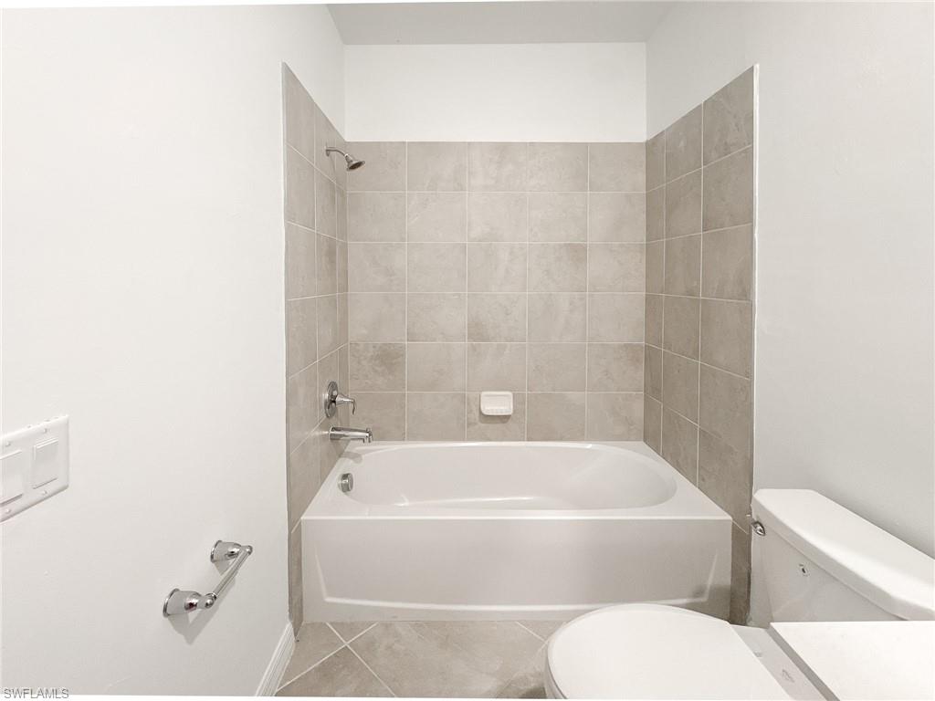 5583 Double Eagle Circle, Unit 4141 Ave Maria, FL 34142 - Photo 18 of 50 a bathroom with a toilet and a bathtub