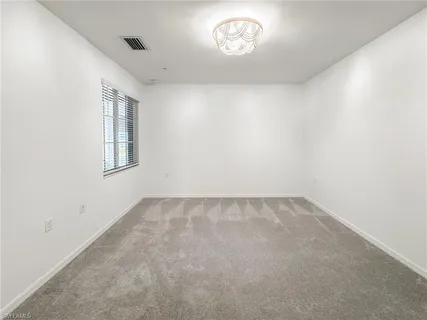 an empty room with a empty space and windows