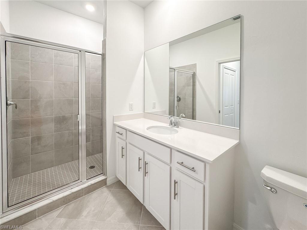 5583 Double Eagle Circle, Unit 4141 Ave Maria, FL 34142 - Photo 26 of 50 a bathroom with a shower sink and mirror