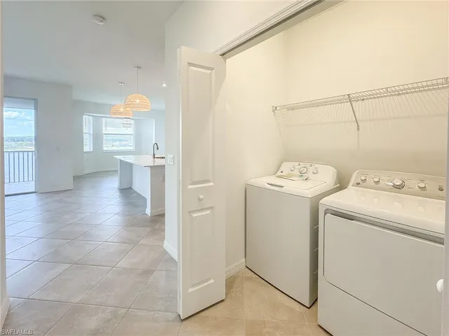 a view of a storage & utility room with dryer and washer