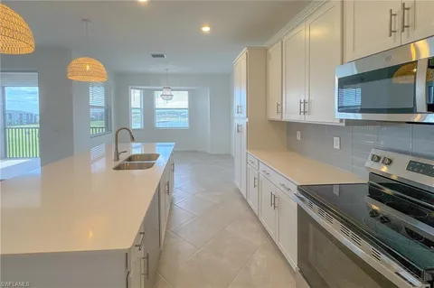 a kitchen with stainless steel appliances a stove a sink and a microwave