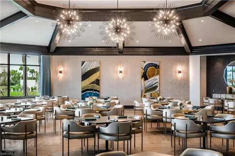 a view of a dining room with furniture and chandelier