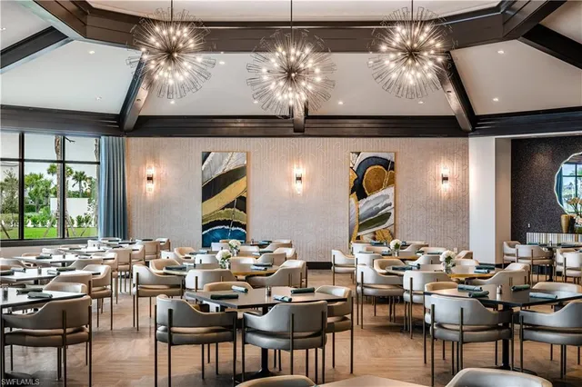a view of a dining room with furniture and chandelier