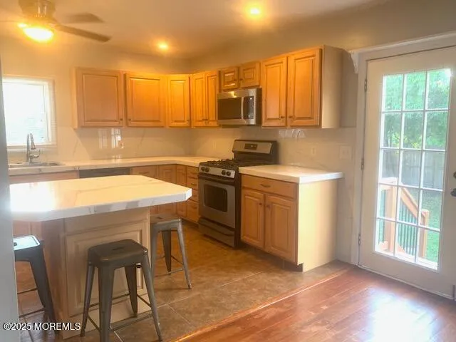 a kitchen with a sink cabinets and a window