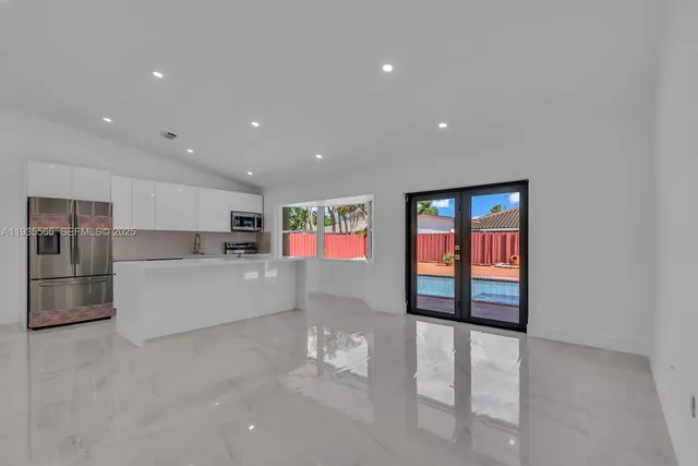 a view of kitchen with furniture and refrigerator