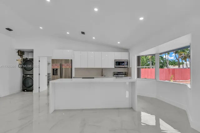 a kitchen with a sink stainless steel appliances and cabinets