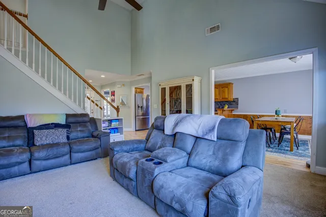 a living room with furniture and a dining table