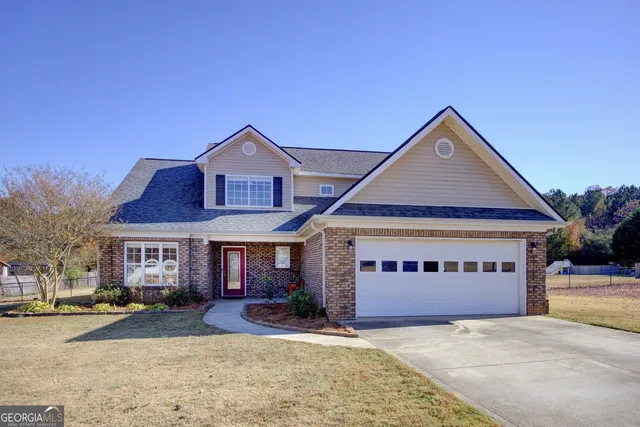 a front view of a house with a yard