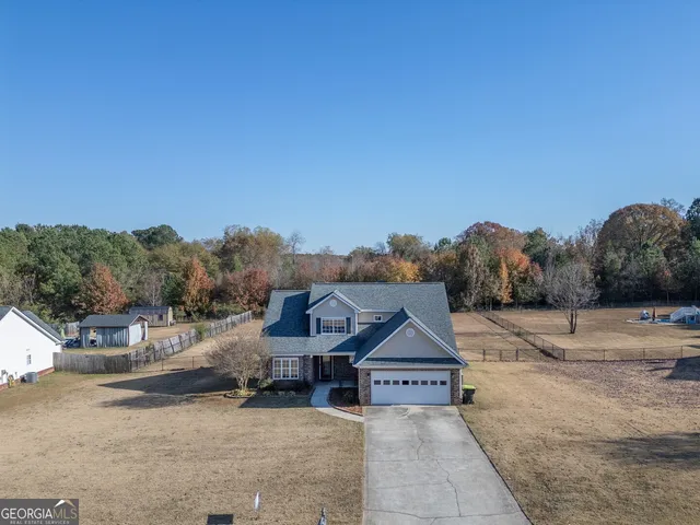 a patio with a table and chairs under an umbrella