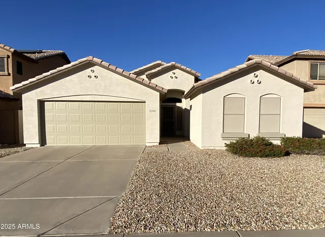 a view of a front of house with a street