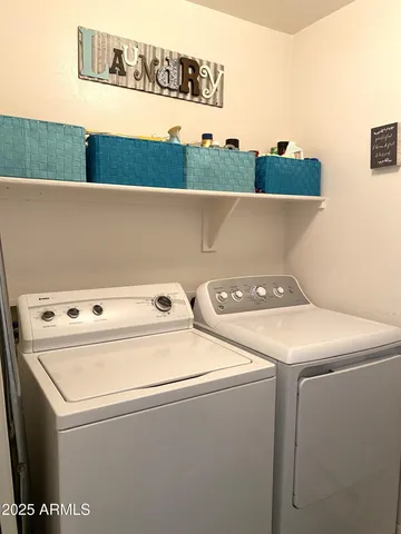 a view of an empty room with furniture and a window