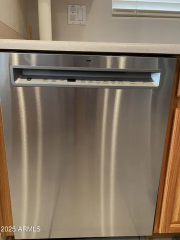 a bedroom with a bed a window and dresser