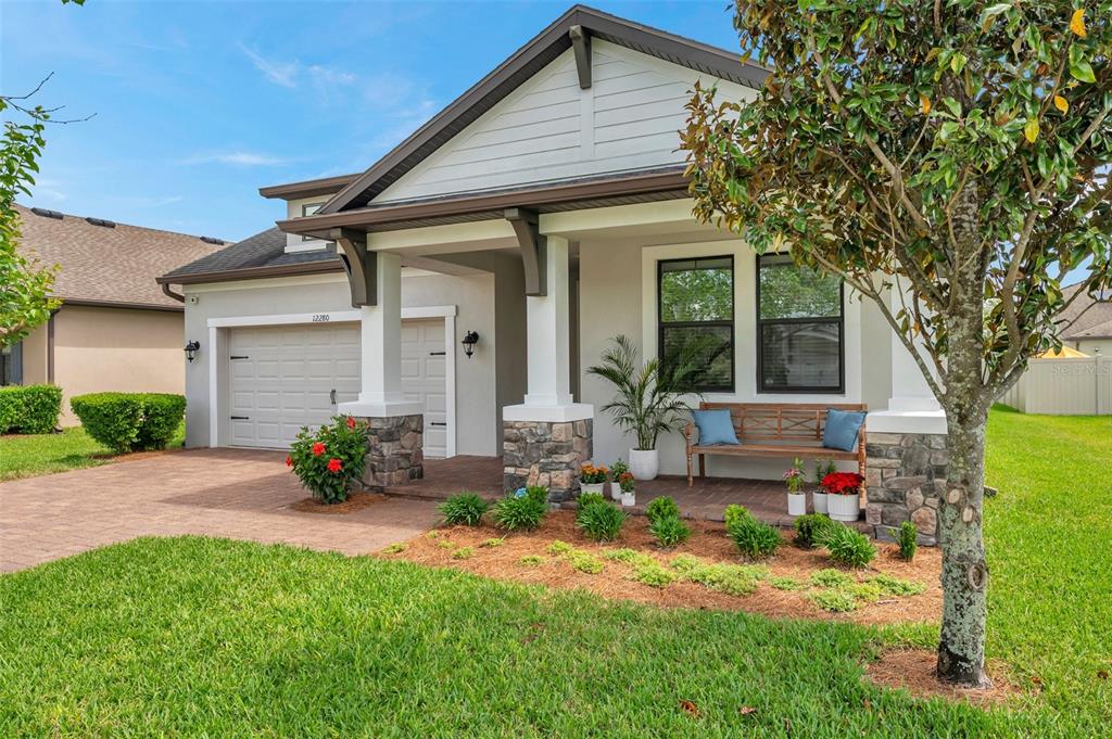 12280 Lyon Pine Odessa, FL 33556 - Photo 1 of 1 a front view of a house with a yard table and chairs