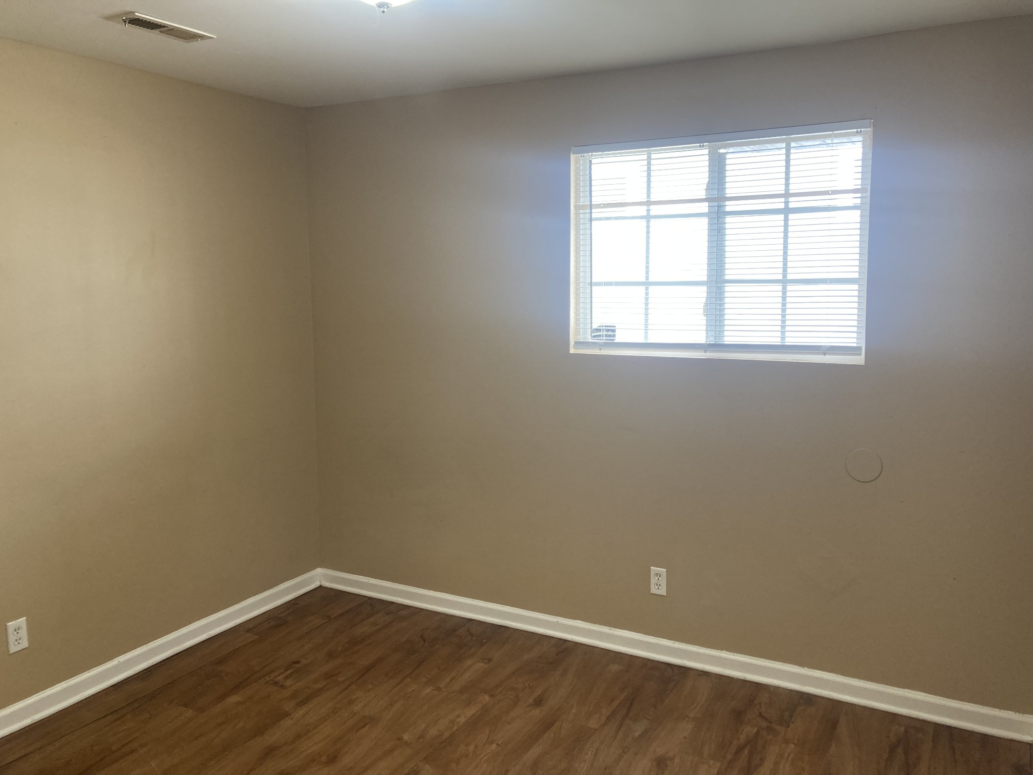 1811 16th Avenue North, Unit B Nashville, TN 37208 - Photo 9 of 13 an empty room with wooden floor and windows
