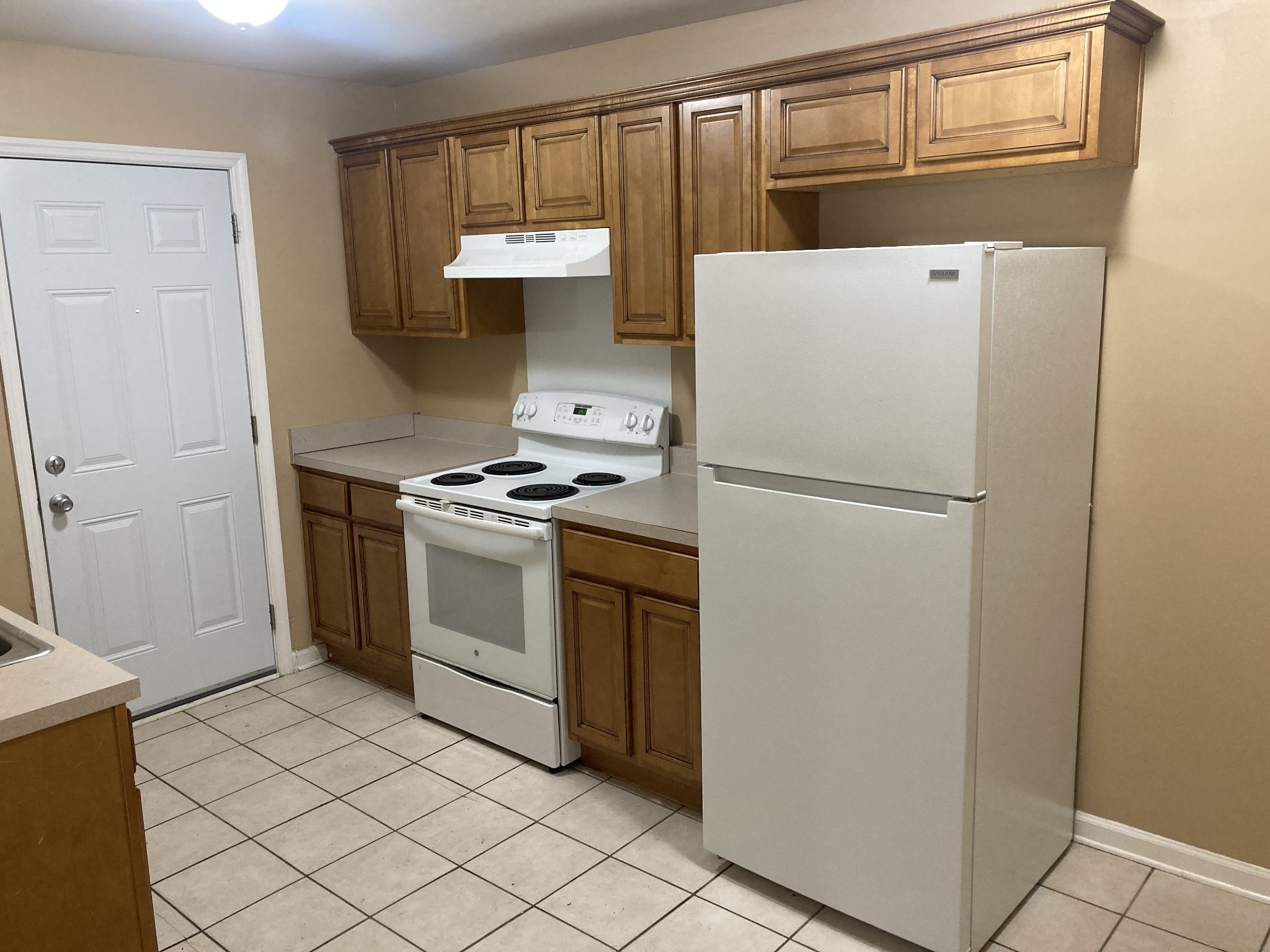 1811 16th Avenue North, Unit B Nashville, TN 37208 - Photo 10 of 13 a white refrigerator freezer and a stove sitting inside of a kitchen