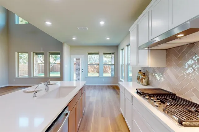 a kitchen with granite countertop a stove and a sink