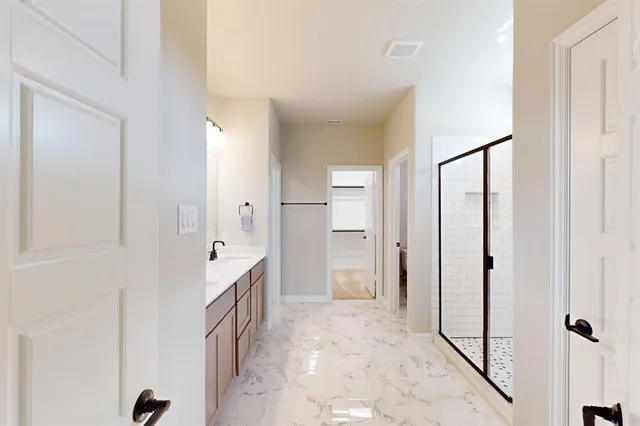 a spacious bathroom with a double vanity sink and a mirror