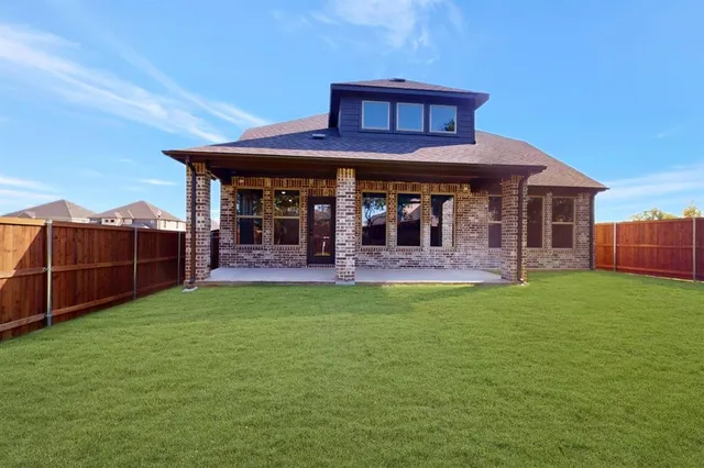 a view of a house with a backyard and porch