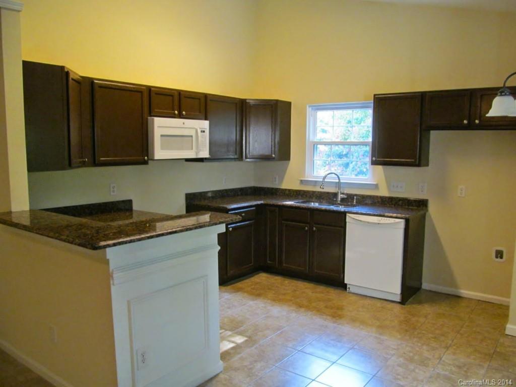5209 Javitz Road Charlotte, NC 28216 - Photo 2 of 10 a kitchen with stainless steel appliances granite countertop a sink stove and refrigerator