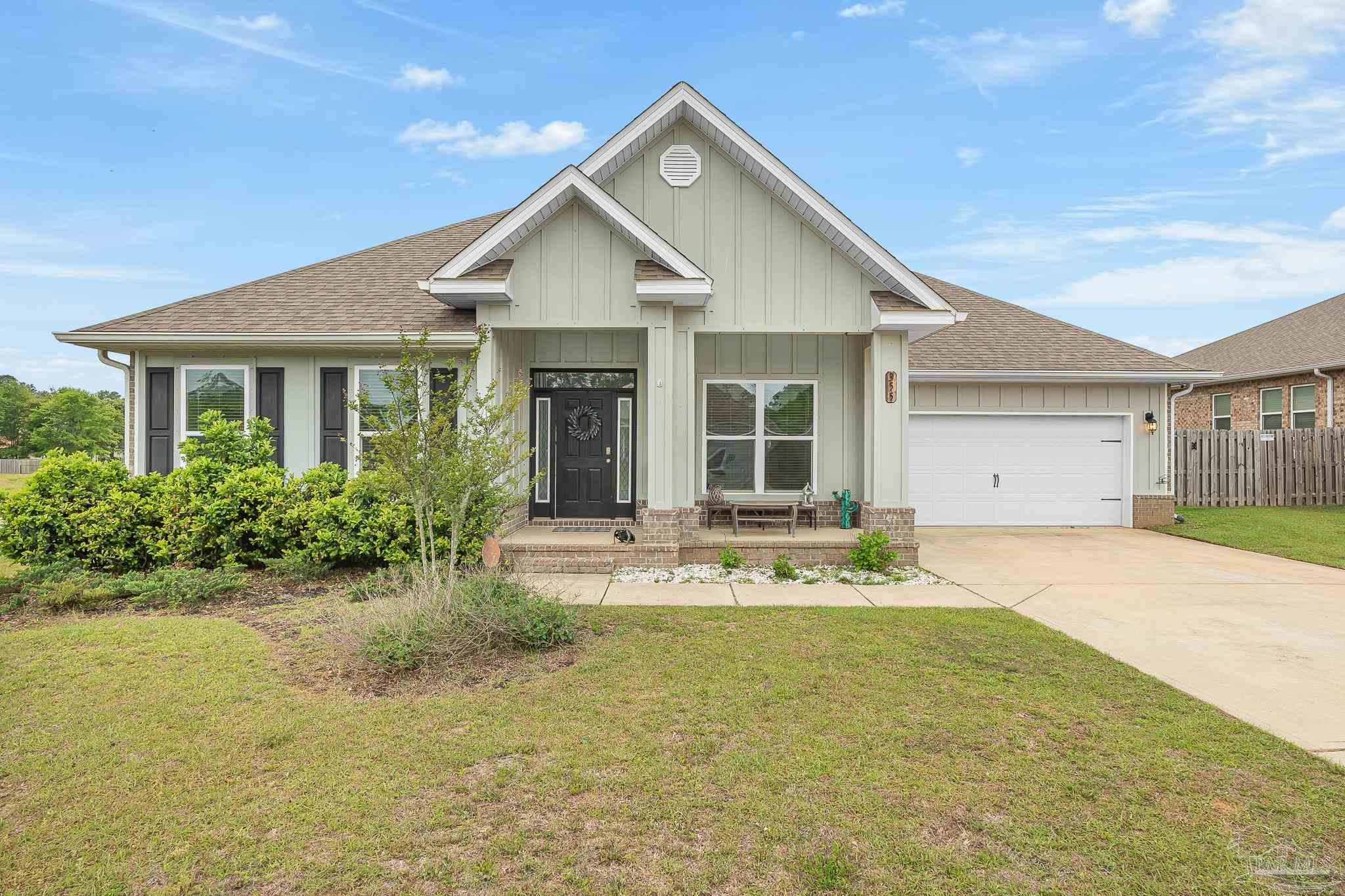 355 Cayden Way Cantonment, FL 32533 - Photo 1 of 61 a front view of a house with a yard outdoor seating and garage