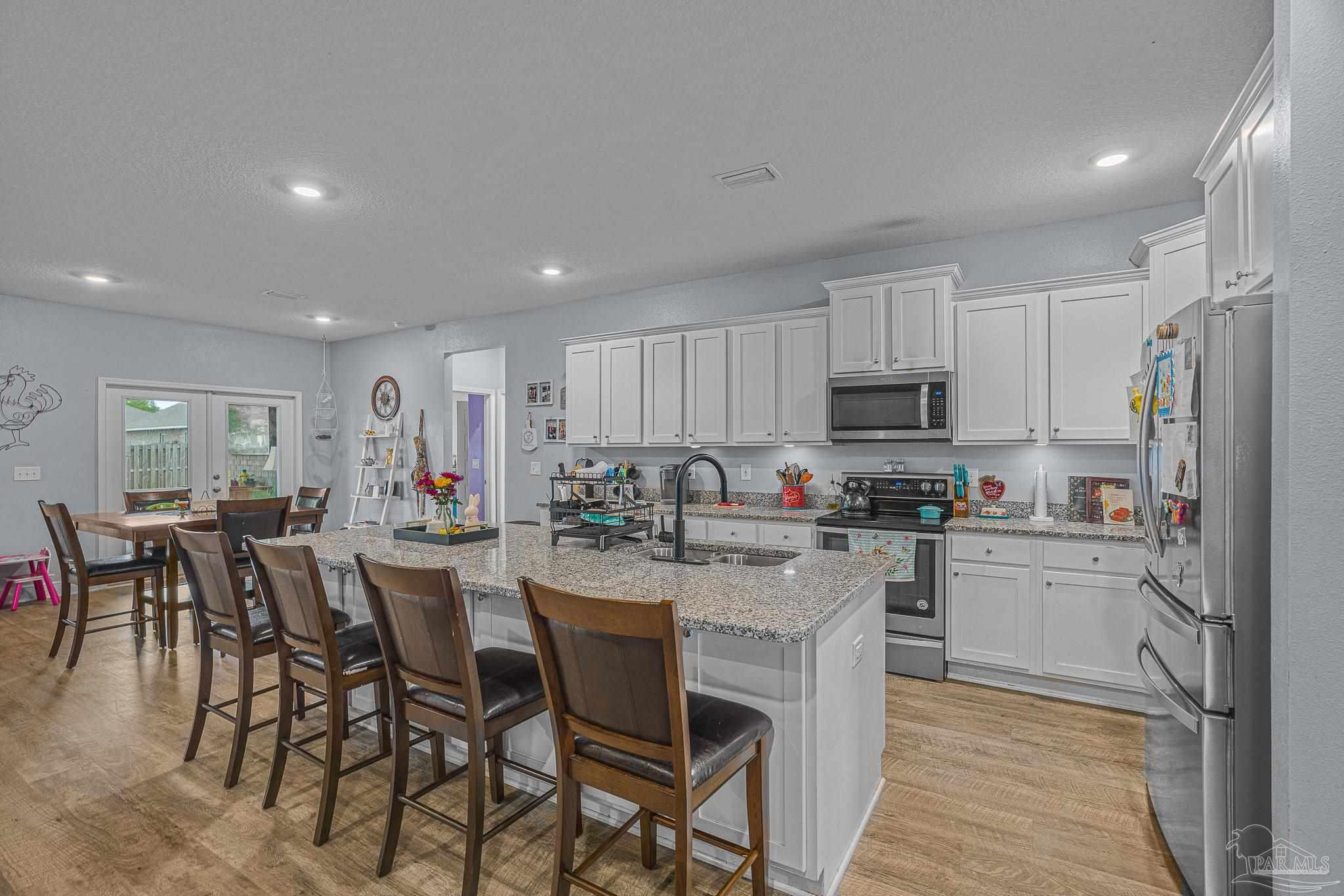 355 Cayden Way Cantonment, FL 32533 - Photo 11 of 61 a kitchen with refrigerator and cabinets