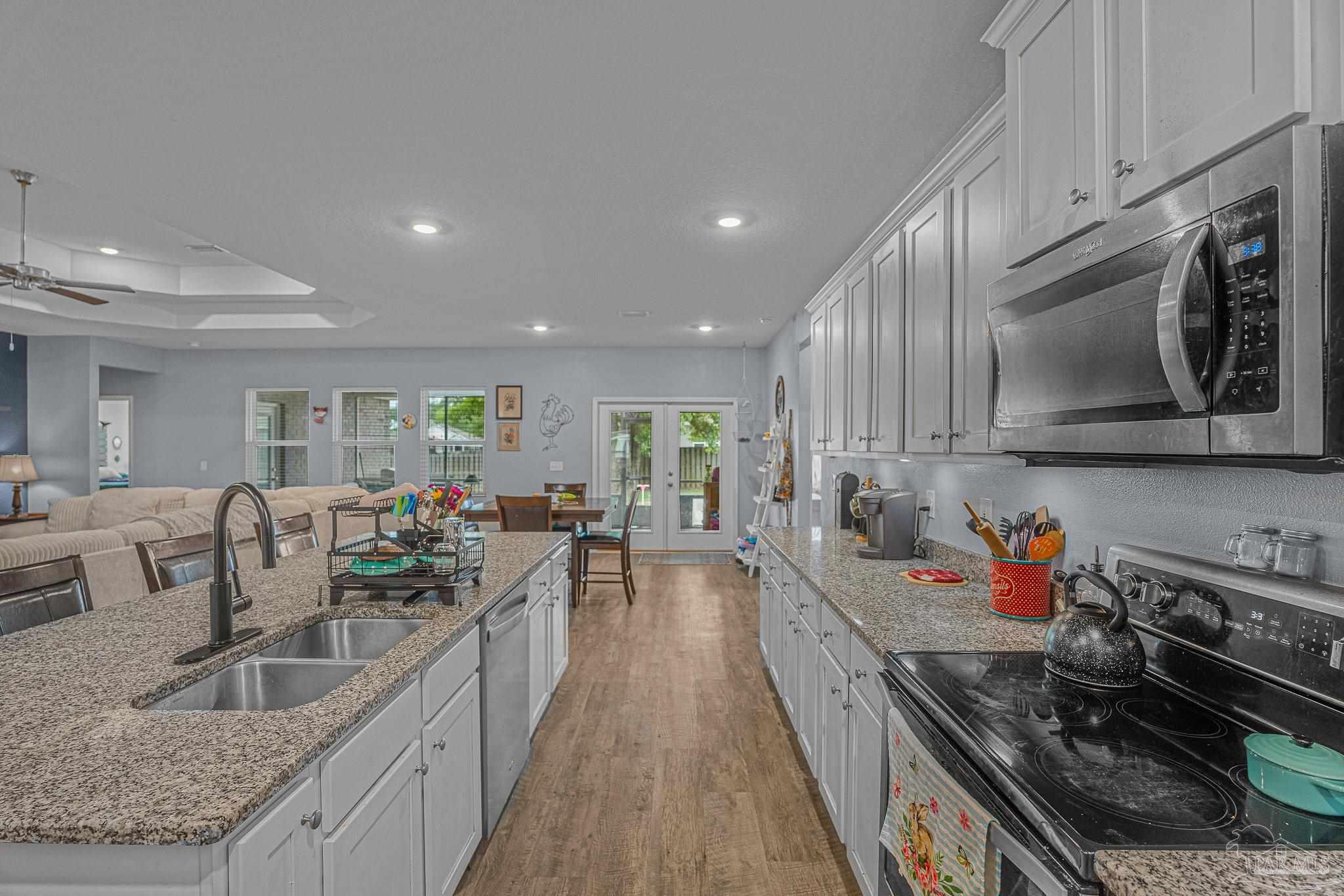 355 Cayden Way Cantonment, FL 32533 - Photo 12 of 61 a large kitchen with stainless steel appliances granite countertop a lot of counter space and wooden floors