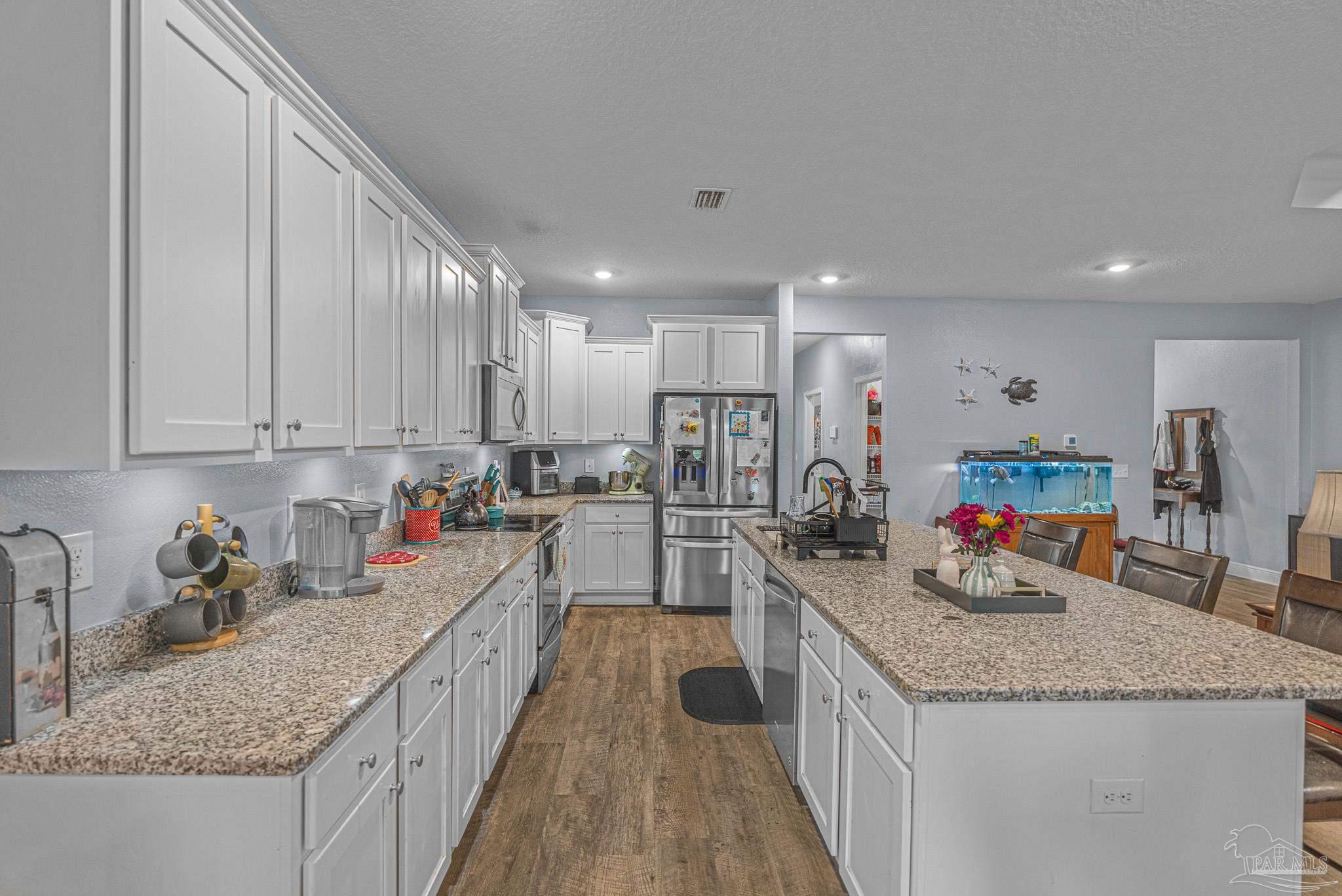 355 Cayden Way Cantonment, FL 32533 - Photo 13 of 61 a kitchen with granite countertop a sink and cabinets