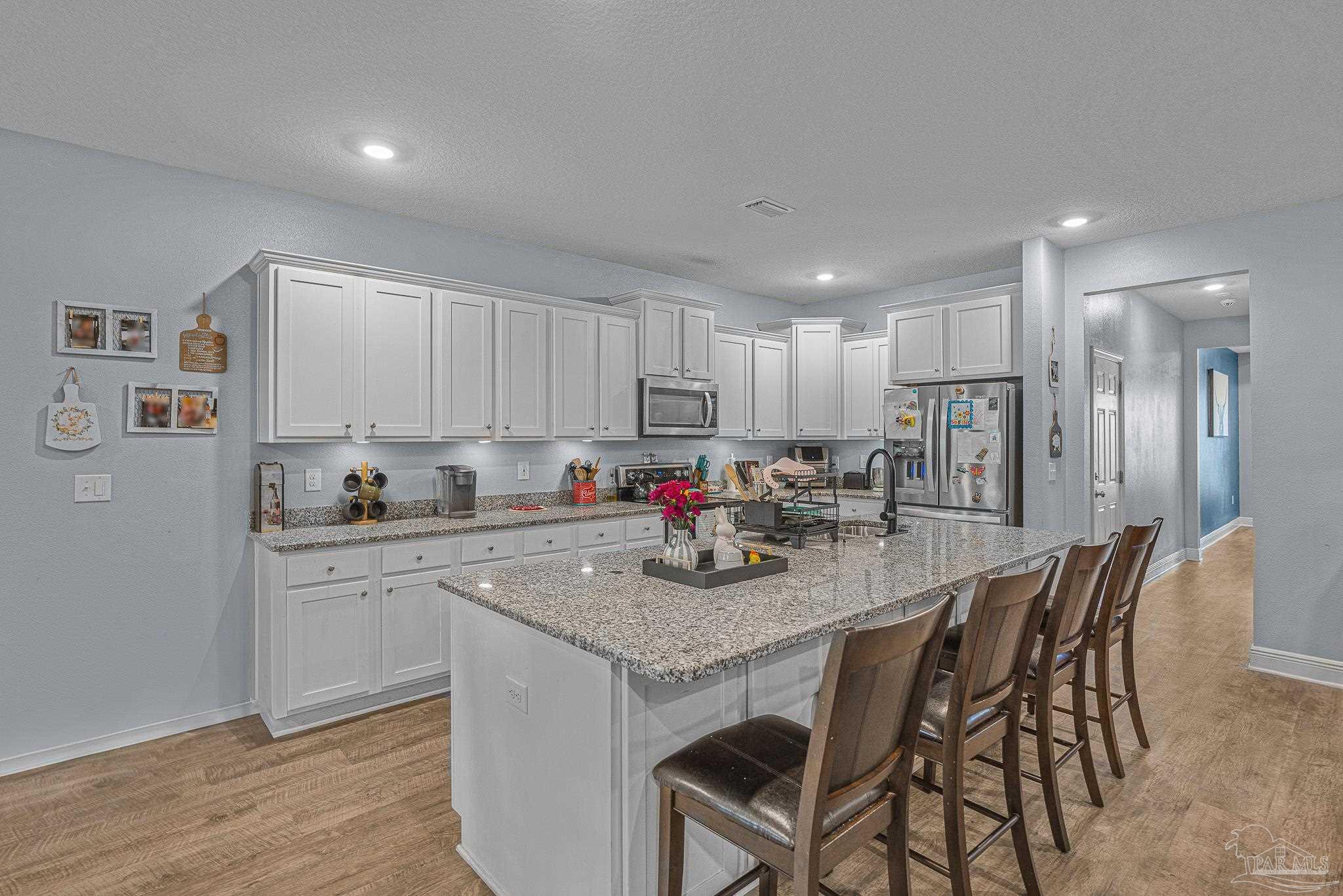355 Cayden Way Cantonment, FL 32533 - Photo 15 of 61 a kitchen with white cabinets and stainless steel appliances