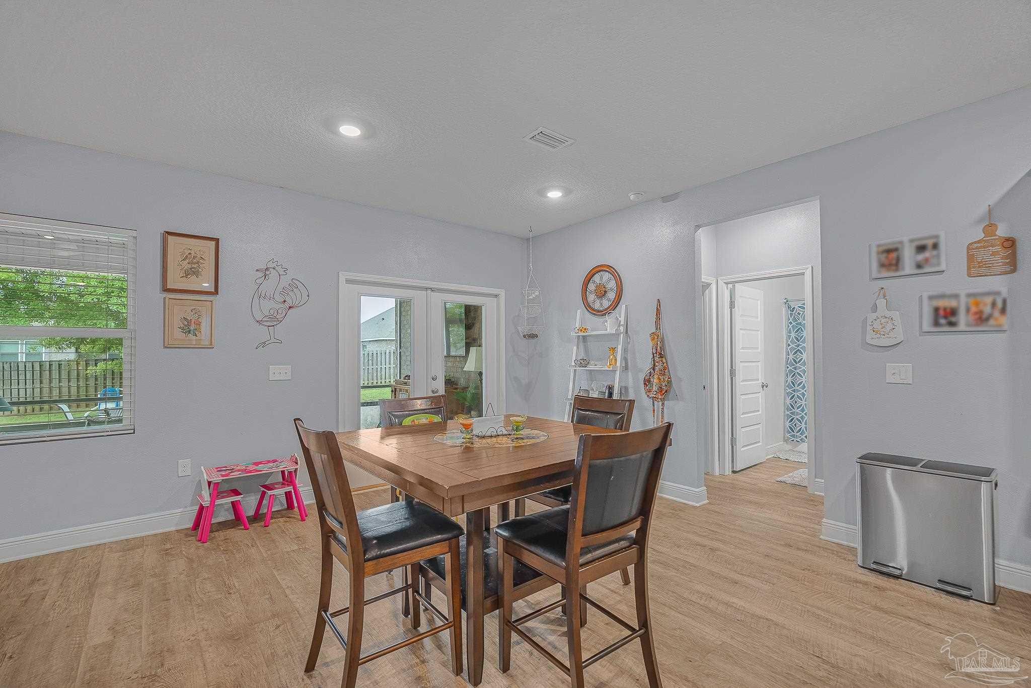 355 Cayden Way Cantonment, FL 32533 - Photo 19 of 61 a view of a dining room with furniture and wooden floor
