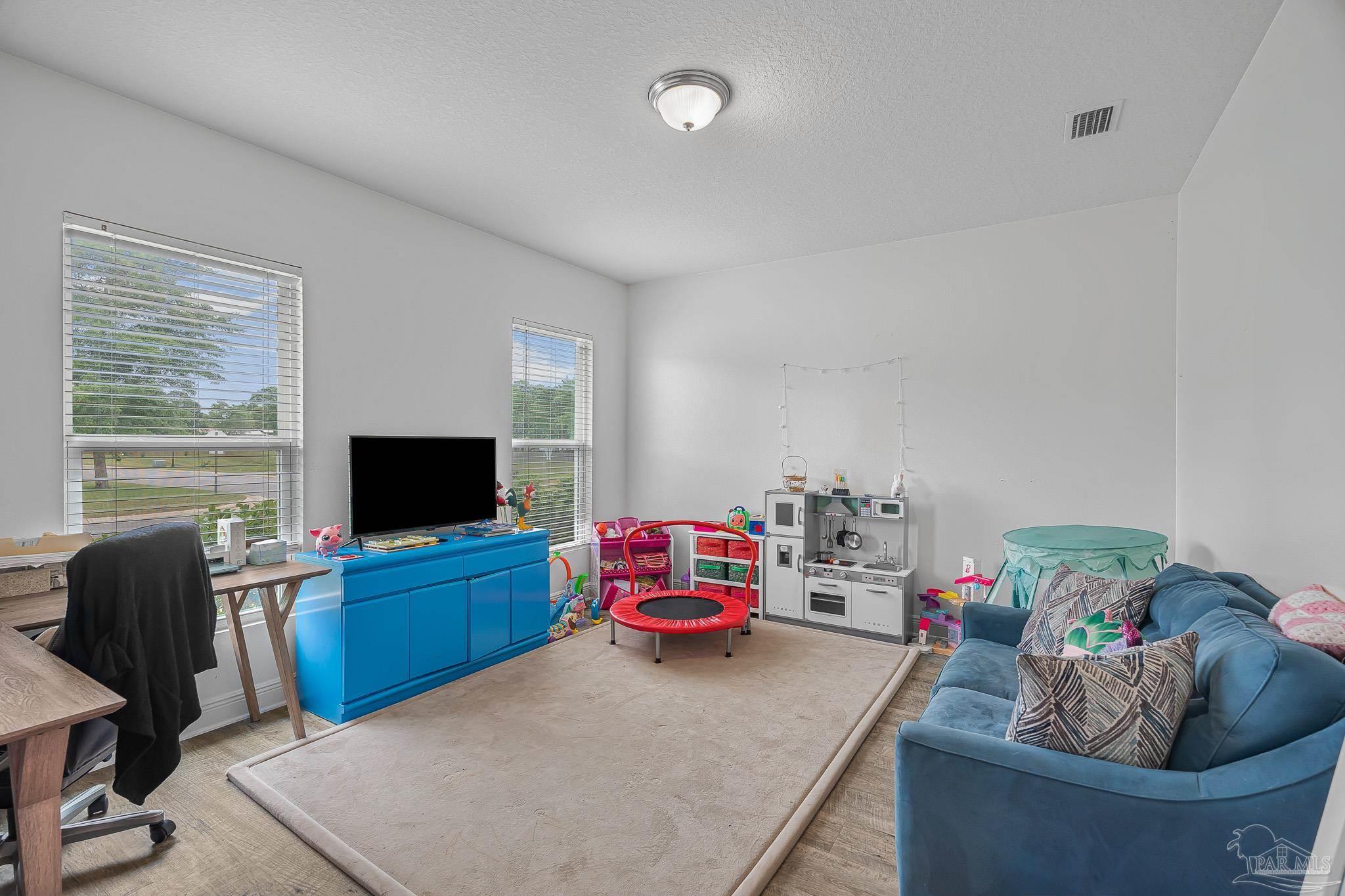 355 Cayden Way Cantonment, FL 32533 - Photo 49 of 61 a living room with furniture and a flat screen tv