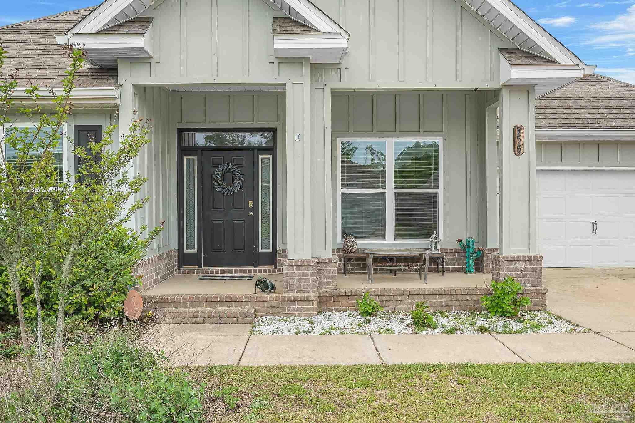 355 Cayden Way Cantonment, FL 32533 - Photo 5 of 61 a front view of a house with large windows and a rug