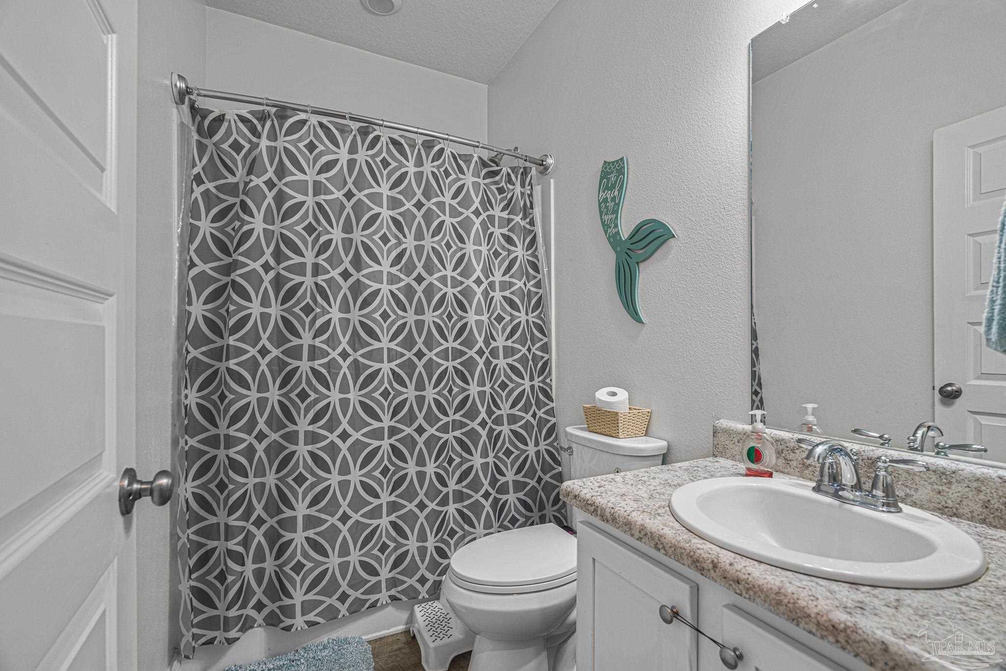 355 Cayden Way Cantonment, FL 32533 - Photo 53 of 61 a bathroom with a granite countertop toilet sink and mirror