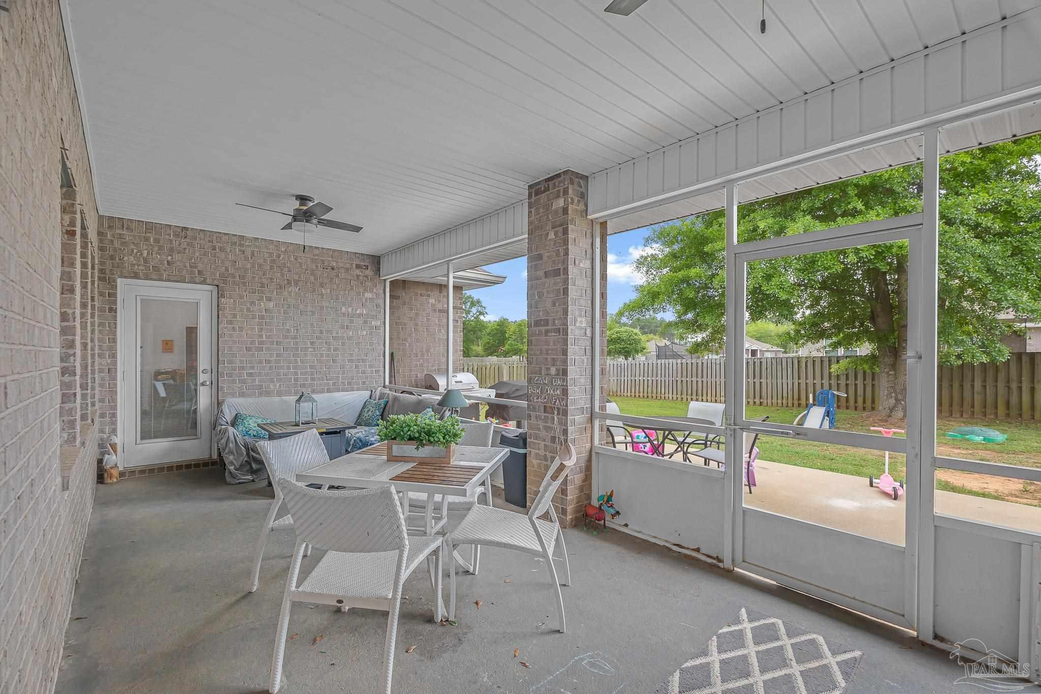 355 Cayden Way Cantonment, FL 32533 - Photo 56 of 61 a dining room with furniture and a floor to ceiling window