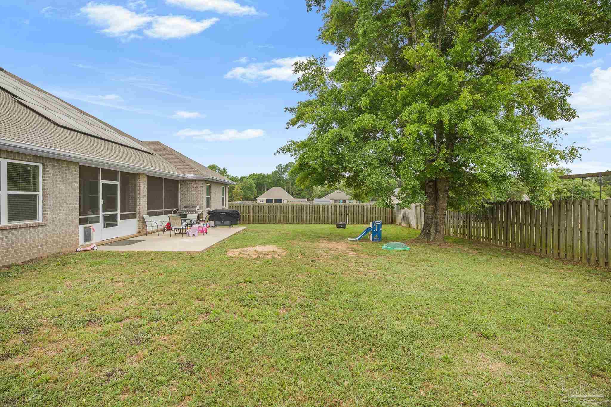 355 Cayden Way Cantonment, FL 32533 - Photo 59 of 61 a backyard of a house with table and chairs