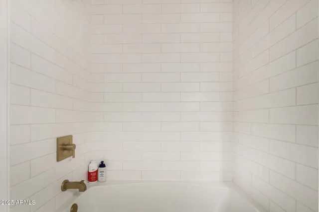 a bedroom with a bed and a lamp