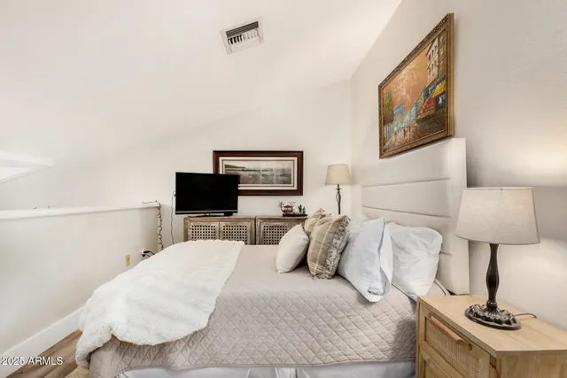 a living room with dining room and wooden floor