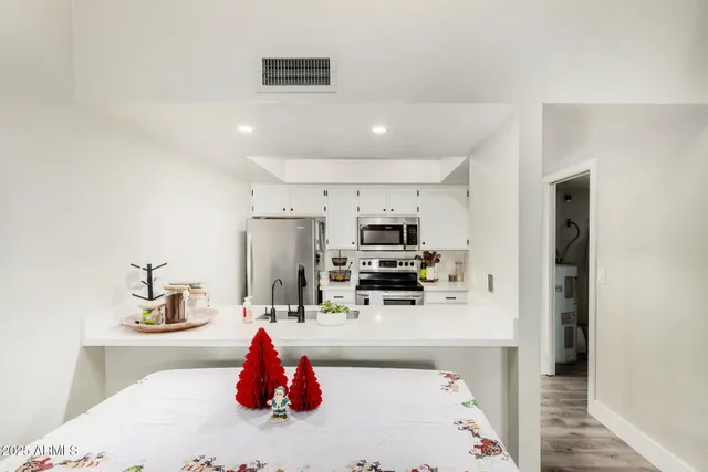 a kitchen with stainless steel appliances a sink and a refrigerator