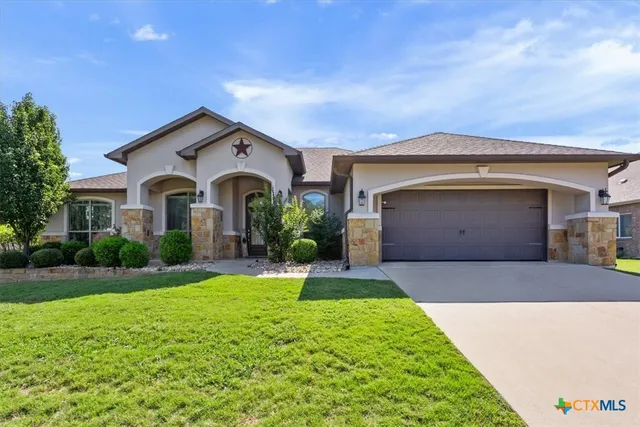 a front view of a house with a yard and garage