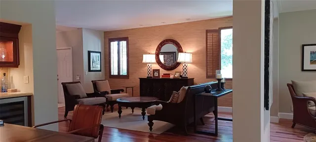 a living room with furniture a mirror and a window