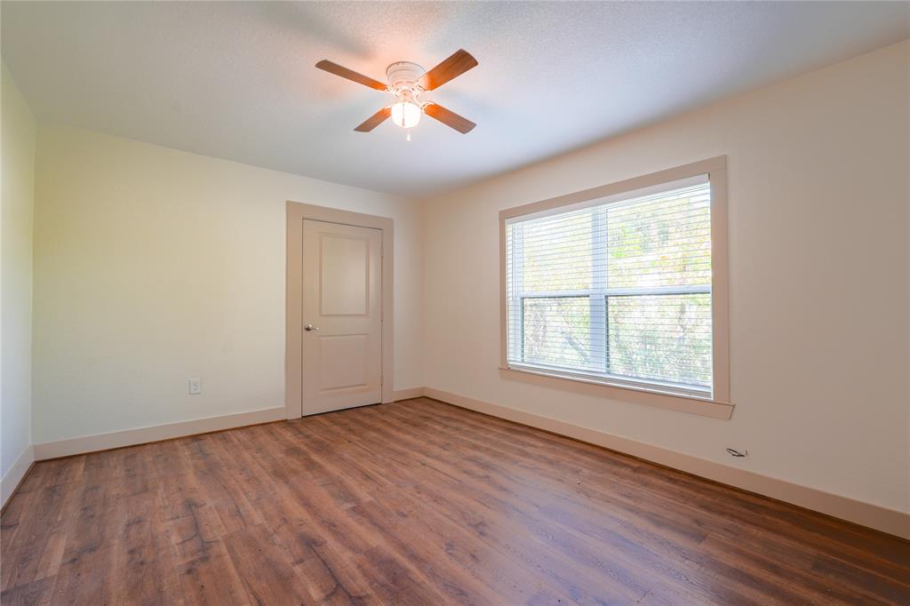 2701 McKenzie Avenue Waco, TX 76708 - Photo 15 of 19 an empty room with wooden floor and windows