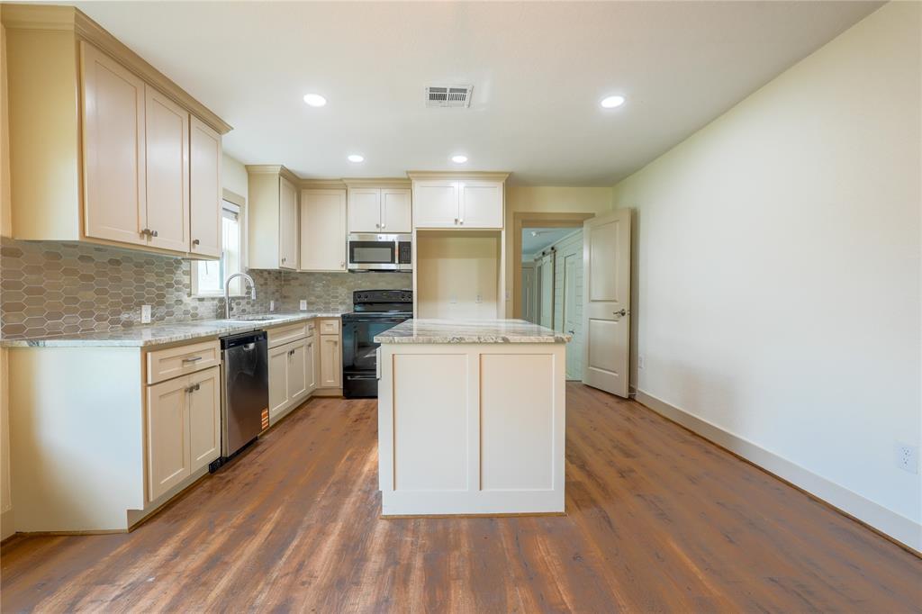 2701 McKenzie Avenue Waco, TX 76708 - Photo 8 of 19 a kitchen with a sink cabinets stainless steel appliances and view living room