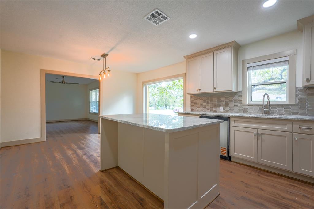 2701 McKenzie Avenue Waco, TX 76708 - Photo 10 of 19 a kitchen with granite countertop a stove a sink and a refrigerator