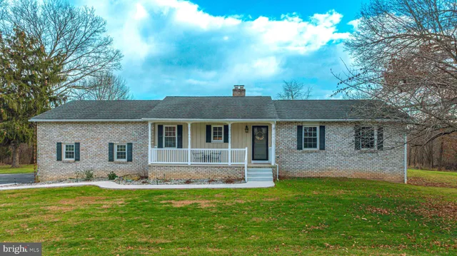 a front view of house with yard and green space