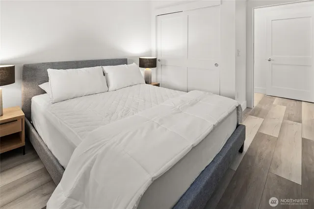 a large bed sitting in a bedroom next to a lamp