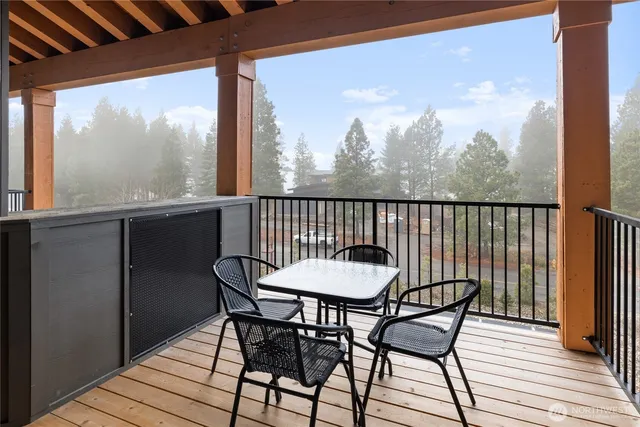 a view of a chair and table on the deck